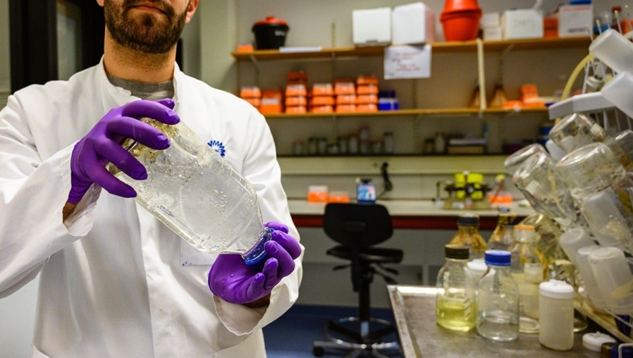 Onderzoeker, met fles in lab, Prinses Máxima Centrum