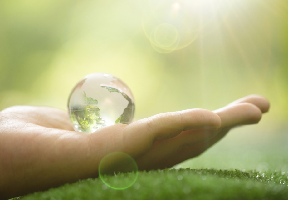 Close up of Green Planet in Your Hands. Save Earth. Environment Concept.